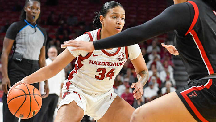Razorbacks' Chrissy Carr looks inside against Texas Tech defense in WNIT game Friday night at Bud Walton Arena.